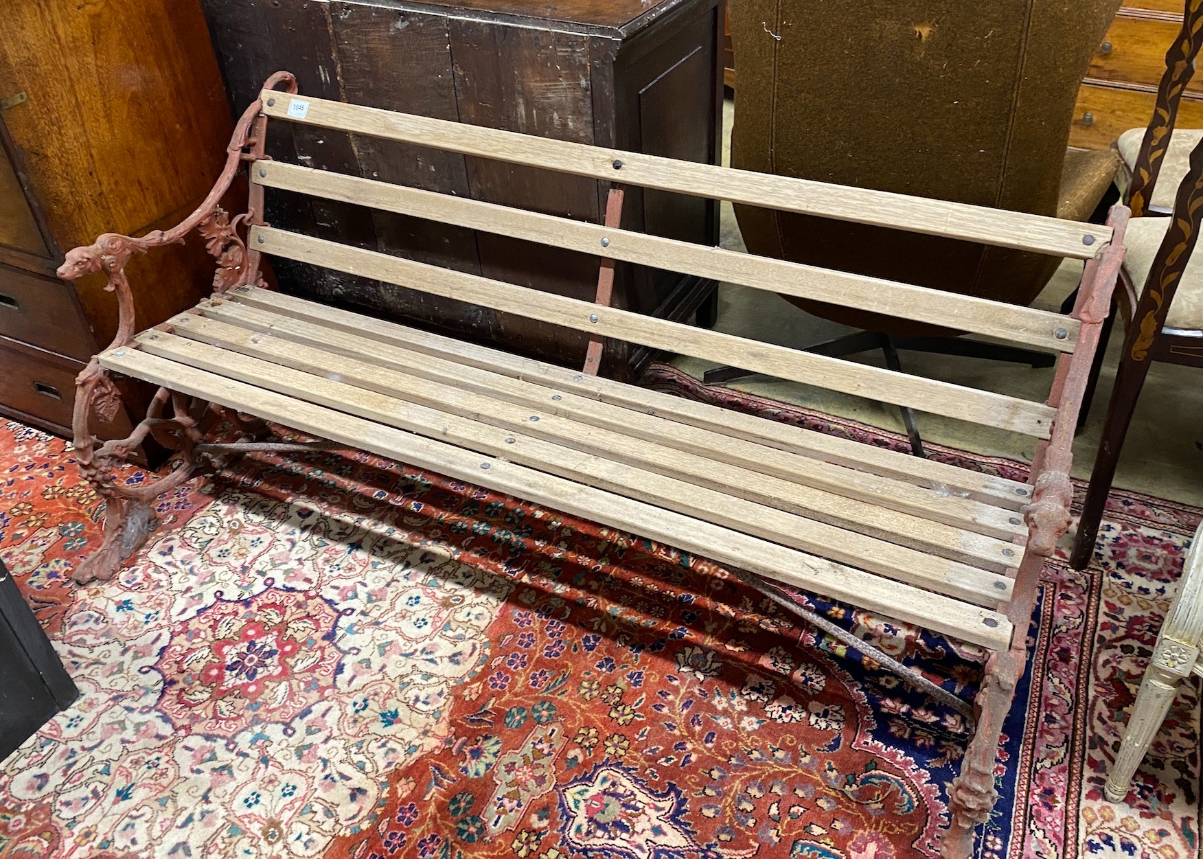 A Coalbrookdale style cast iron garden bench with dog's head and serpent terminals, length 158cm
